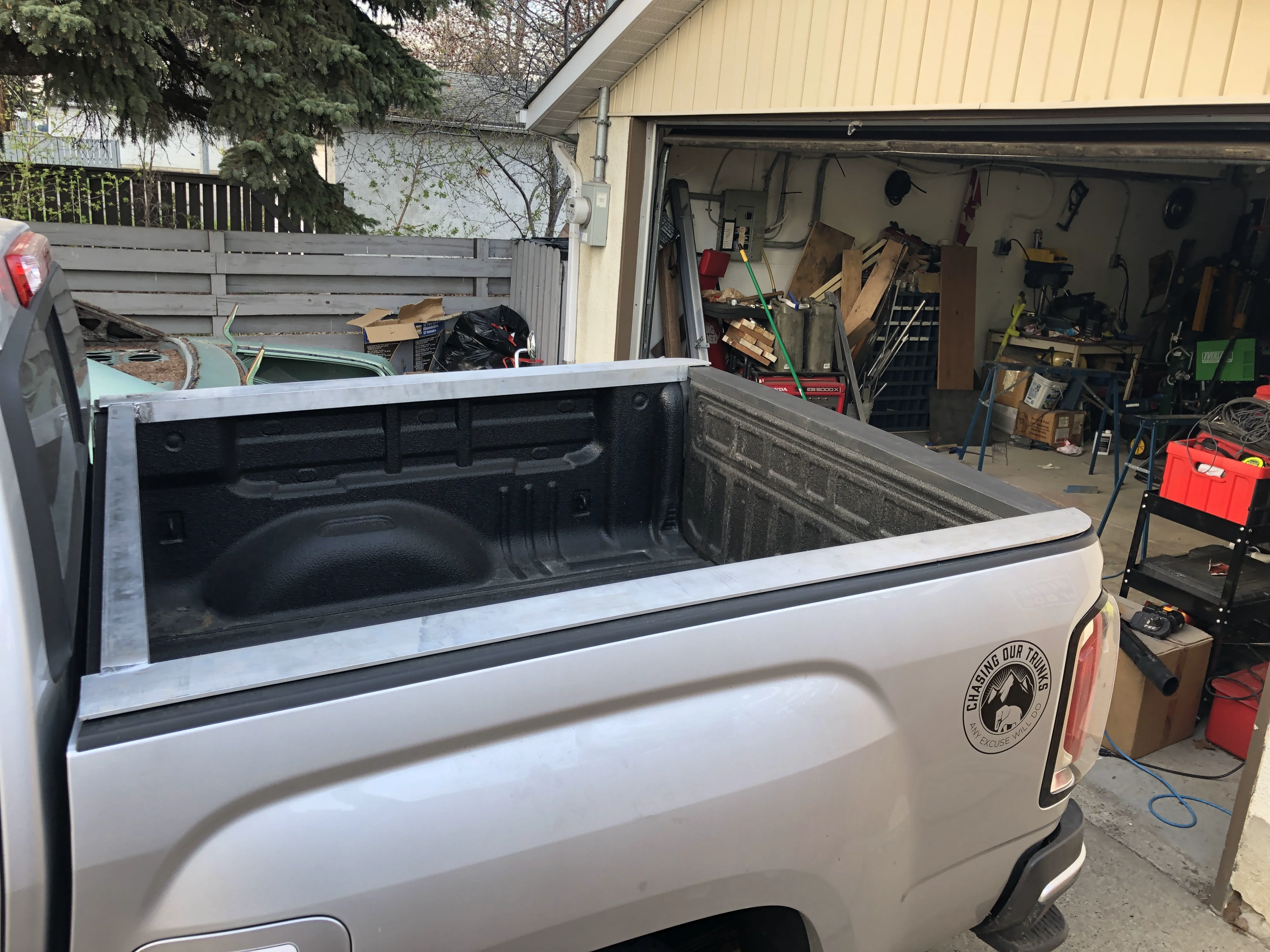 Aluminum base rails with contoured ends to match truck body lines